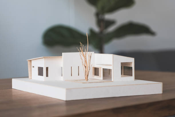 istock An architecture model on wooden table in office with blur nature background 1056120704