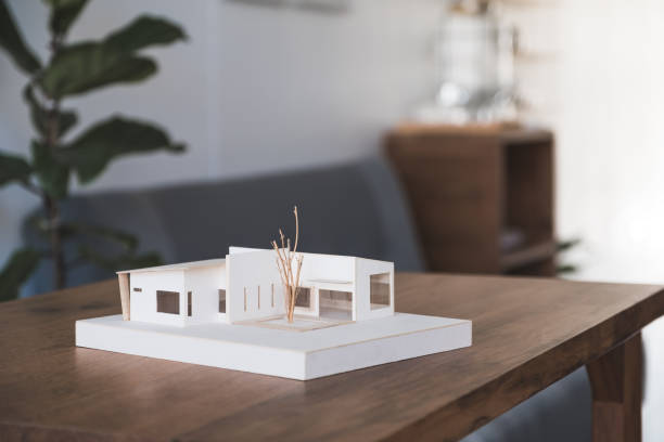 istock An architecture model on wooden table in office with blur nature background 1056120766