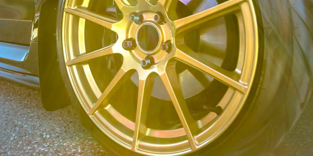 istock Tire rim with disc brake seen between gold spokes 1056124242
