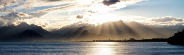 Seascape image of high mountains over cloudy sunset sky in Antalya, Turkey