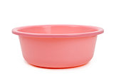A pink plastic bowl in front of a white backdrop