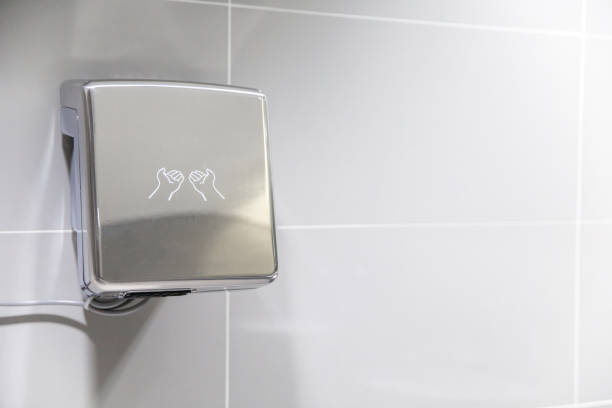 istock Automatic bathroom hand dryer in public WC toilet 1056151020