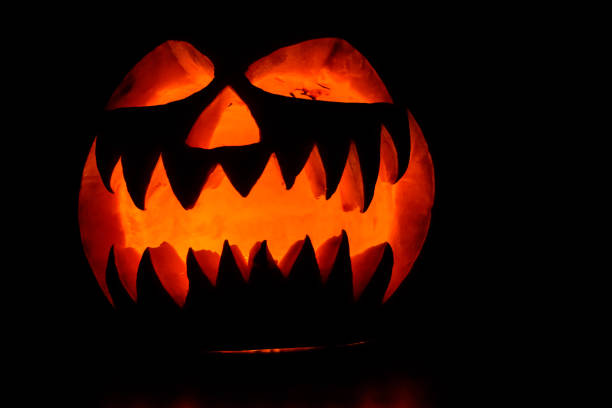 istock Spooky halloween pumpkin on a black background 1056156520