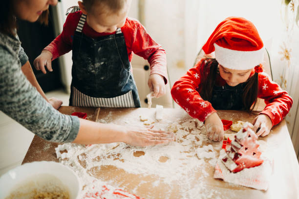 istock Happy kids with mother making cookies 1056161672