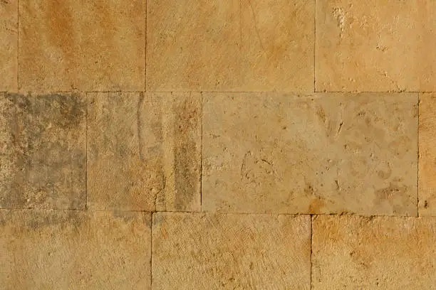 Photo of Large yellow rectangular plates. Very smooth old wall