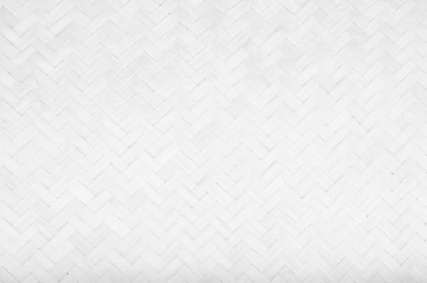istock Gray Mat Traditional handicraft bamboo weave texture background. Wicker surface pattern material for wall with antique cracking furniture painted weathered white vintage peeling wallpaper or board. 1056174386