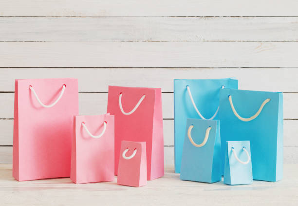 istock paper bags on wooden background 1056181602