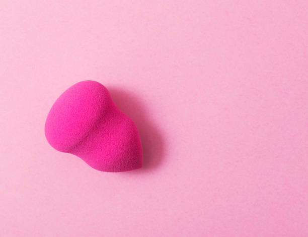 istock pink sponge on pink paper background 1056181622