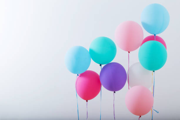 istock balloons on white wooden background 1056181724