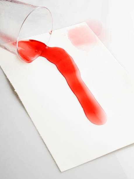 istock Stained,Red wine spilling from glass 1056190388