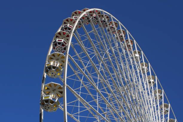 istock Ferris wheel against blue sky 1056191810