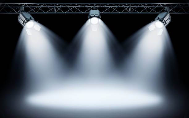 istock Bright stage spotlights shining on dark background. 3d rendering 1056193950