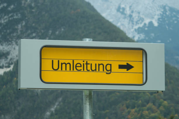 istock Signpost diversion with mountains in the background 1056195378