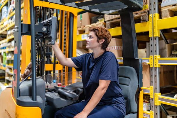 istock Female worker operating forklift in warehouse 1056195904
