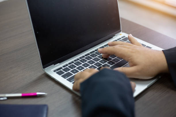 istock businessman hands searching for data on Notebook with analyzing charts at his workplace.concept 1056196072