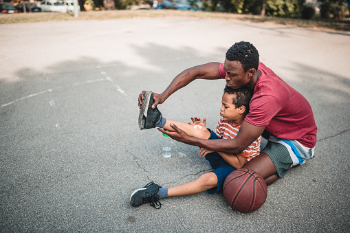 Father and son playing basketball. Belgrade, Serbia