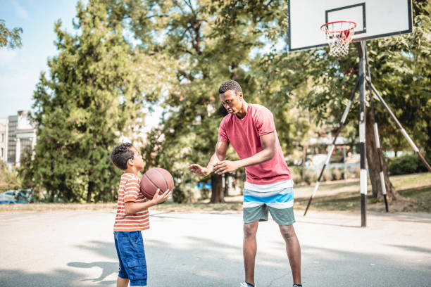 istock Father and son playing basketball 1056196678