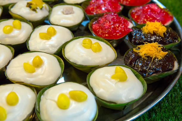istock Making of Thai pudding with coconut topping as know as Ta-ko 1056198426