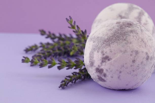 istock lavender bath bomb.Organic body cosmetics with lavender extract.light purple bath bombs and sprigs of lavender on a purple background 1056200842
