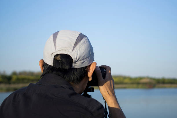 istock man taking pictures with camera in wetland 1056202704