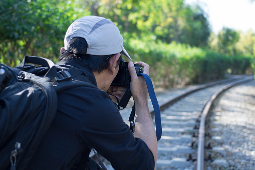 photographer taking pictures on railroad