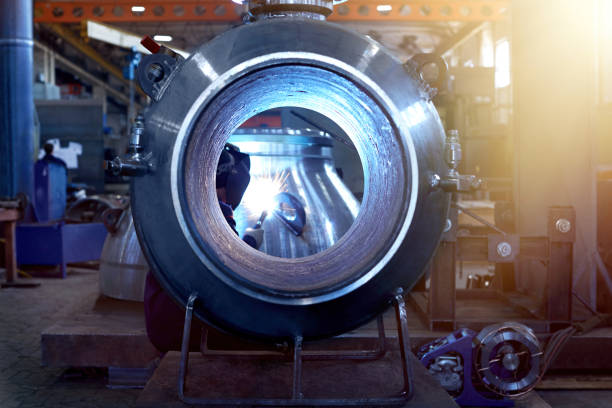 istock Welder in goggles and a helmet, welds metal structures 1056202752