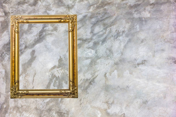istock Old antique gold frame on grey stain concrete wall with stain for background. 1056206108