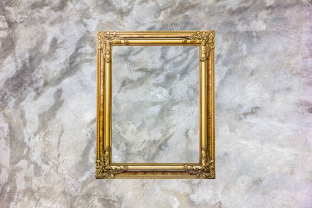 istock Old antique gold frame on grey stain concrete wall with stain for background. 1056206130