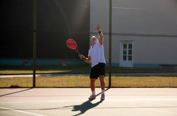 istock an elderly man playing tennis 1056210070