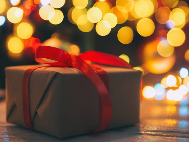 istock gift on a wooden table in the night 1056210828