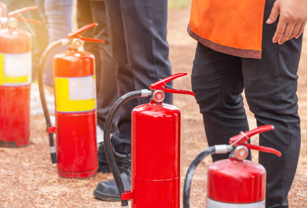Row of fire extinguisher during training basic fire fighting Row of fire extinguisher during training basic fire fighting for volunteers fire extinguisher photos stock pictures, royalty-free photos & images