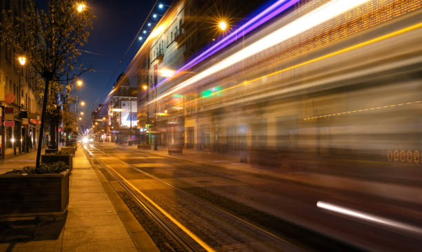 istock Light trails of a tram driving a street by night 1056212874