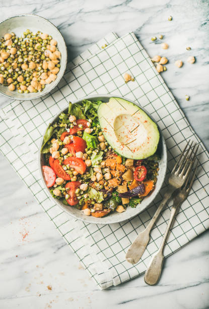 istock Vegan bowl with avocado, grains, beans and vegetables, top view 1056213174
