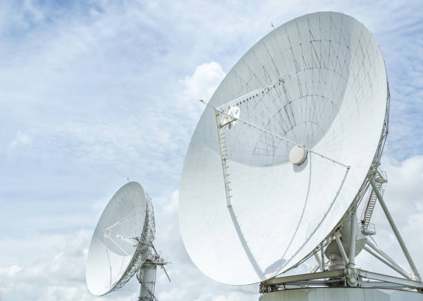 radio antenna astronomy dish turn up skyward on blue sky