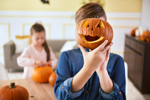 istock Boy with scary Halloween pumpkin 1056214750