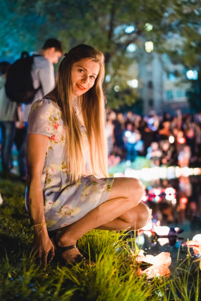 istock Young womant with chinese lanterns floating in lake 1056214796