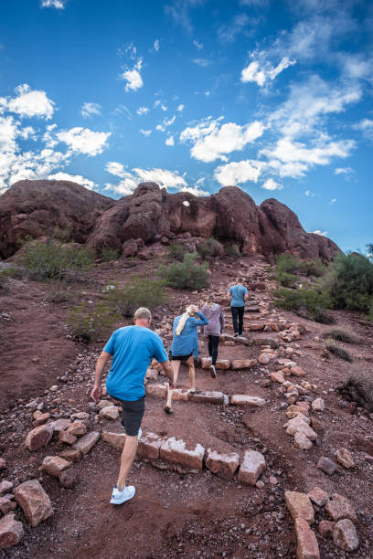 Stairway to Hole-in-the-Rock Sightseers climb the Devil's Stairway to Hole-in-the-Rock, a popular geological attraction in Phoenix, Arizona. It was once used by the ancient Hohokam people to mark the solstices. phoenix stone stock pictures, royalty-free photos & images