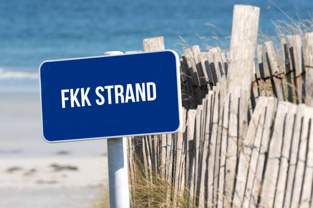 istock Beach, sea and a sign with the reference to nudist beach 1056214908