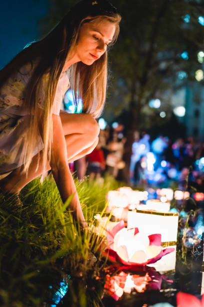 istock Young womant with chinese lanterns floating in lake 1056214970