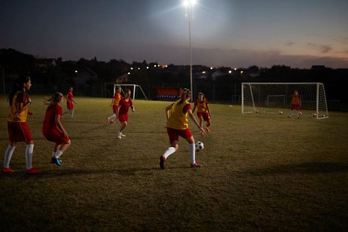 Women's Soccer Team On Training by Night on Soccer Stadium.