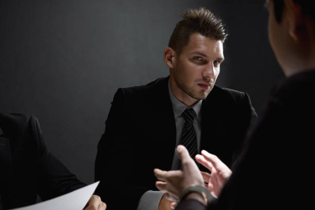istock Detectives in interrogation room with suspect or criminal man 1056215364