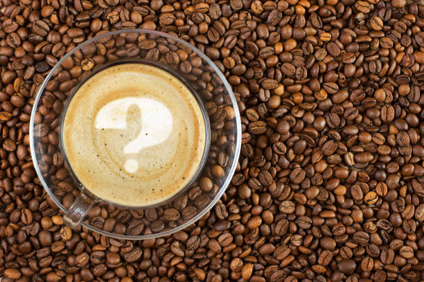 istock Cup of espresso with question mark on coffee foam on coffee beans background. With copy space 1056216292