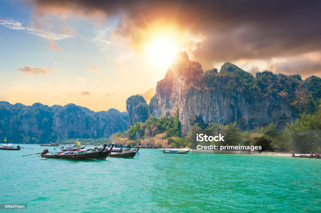 Beautiful sunset at tropical sea with long tail boat in south thailand Phuket Island Stock Photo