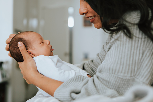 Mother holding her infant baby