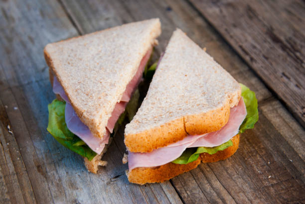 istock Club Sandwich with Ham and Vegetables. Rustic wooden background. 1056218556