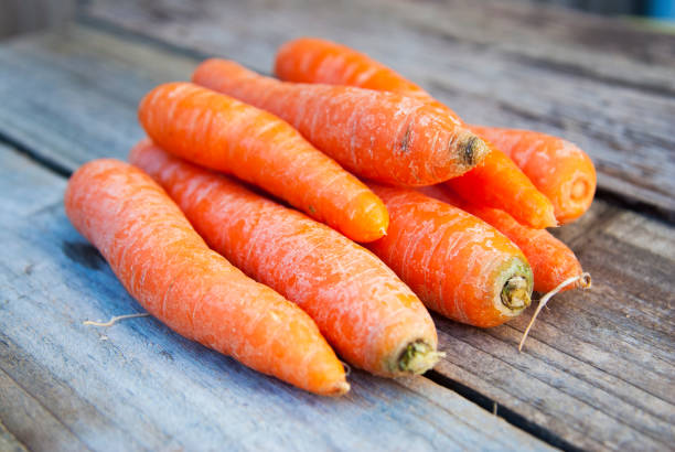istock Fresh Harvested Carrot on Wooden Table. Vegetables Vitamins Keratin. Top View Flat Lay. Rustic Style. Country Village Agriculture concepts 1056218566