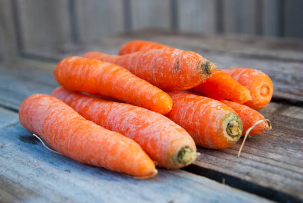 istock Fresh Harvested Carrot on Wooden Table. Vegetables Vitamins Keratin. Top View Flat Lay. Rustic Style. Country Village Agriculture concepts 1056218676