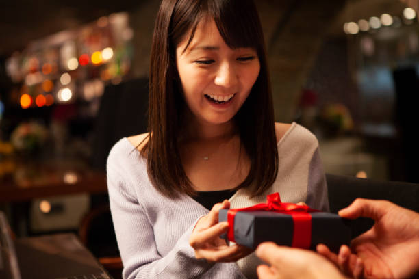 A surprise gift Young men gives his girlfriend a surprise gift japanese girlfriends stock pictures, royalty-free photos & images