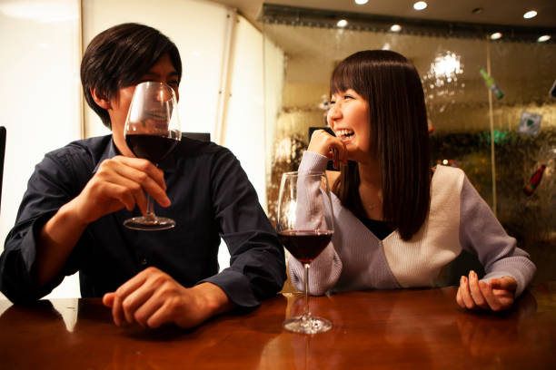 istock A men is drinking wine in the restaurant with girlfriend 1056220650