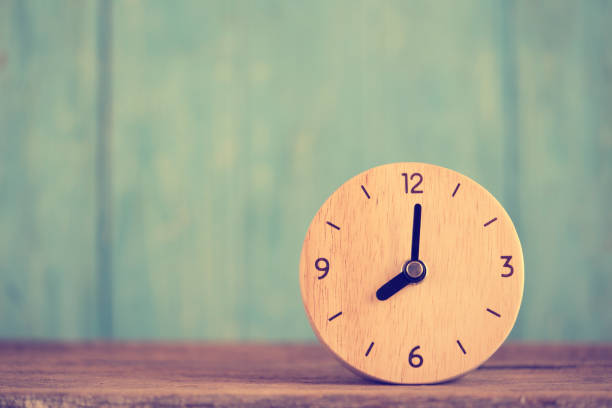 istock Retro alarm clock on wooden table, vintage style 1056224076